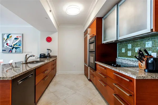 a kitchen with stainless steel appliances granite countertop a refrigerator and a stove top oven