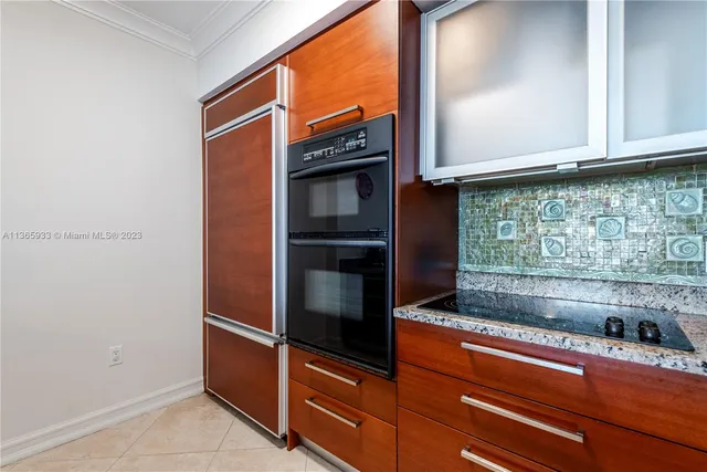 a kitchen with stainless steel appliances granite countertop a sink and a refrigerator