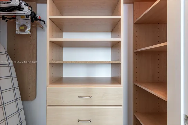 a large bed sitting in a bedroom next to a window
