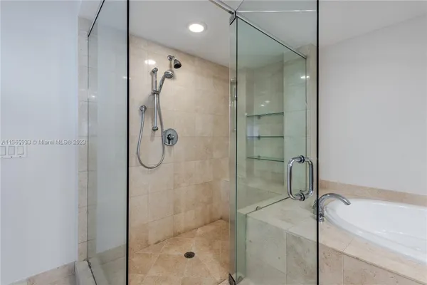 a bathroom with a shower sink mirror and toilet