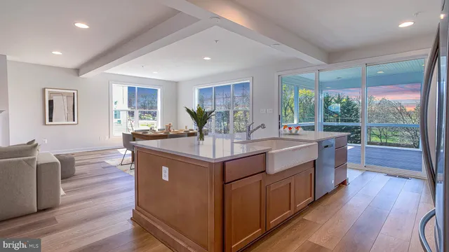 a kitchen with stainless steel appliances granite countertop a stove and a large window