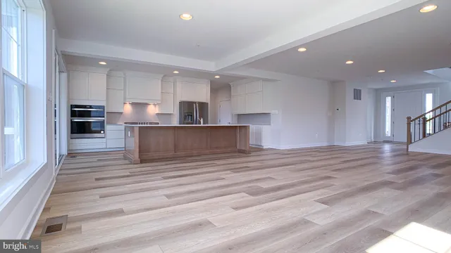 a view of kitchen with kitchen island sink refrigerator and stove