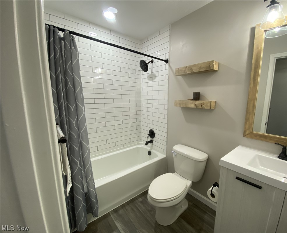 2113 Fowl Road Elyria, OH 44035 - Photo 22 of 39 Full second floor bathroom for family with vanity, toilet, shower / bath combo, and hardwood / wood-style flooring