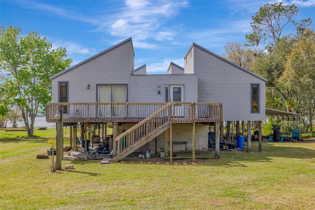 a view of a swimming pool with a bench and trees