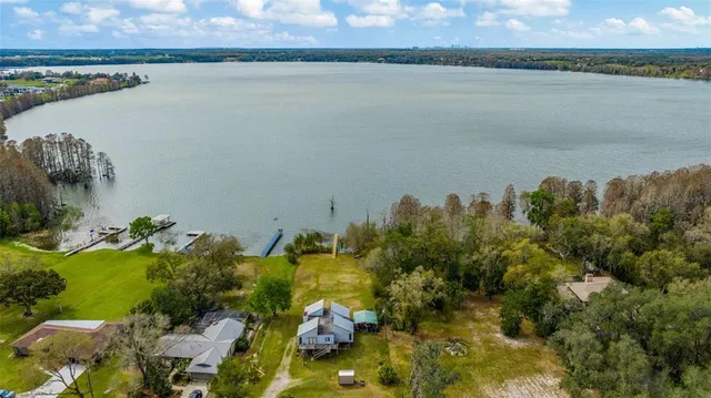 a view of a livingroom with wooden floor and a ceiling fan