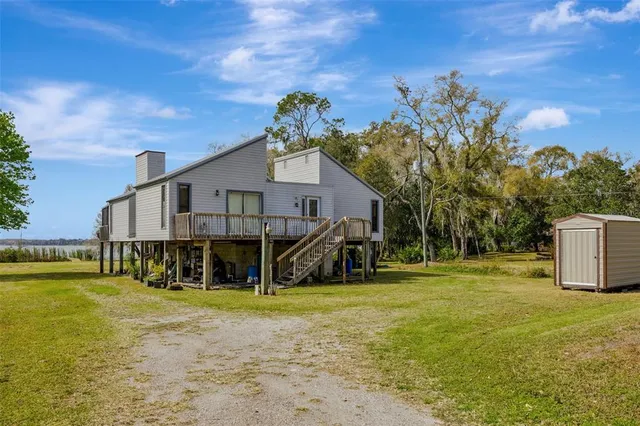 a front view of a house with a big yard