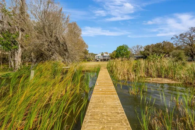 a view of a house with a yard and a car