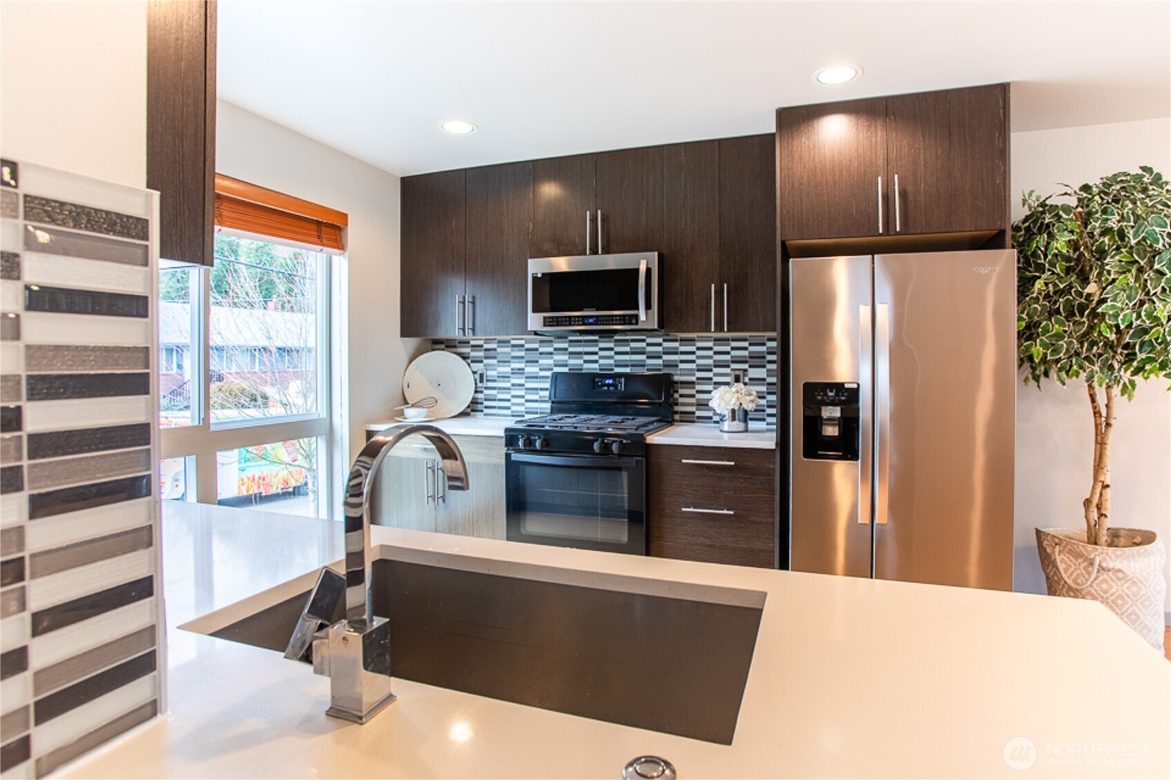 1465 South Columbian Way Seattle, WA 98144 - Photo 17 of 35 a kitchen with stainless steel appliances kitchen island granite countertop a refrigerator and a stove top oven