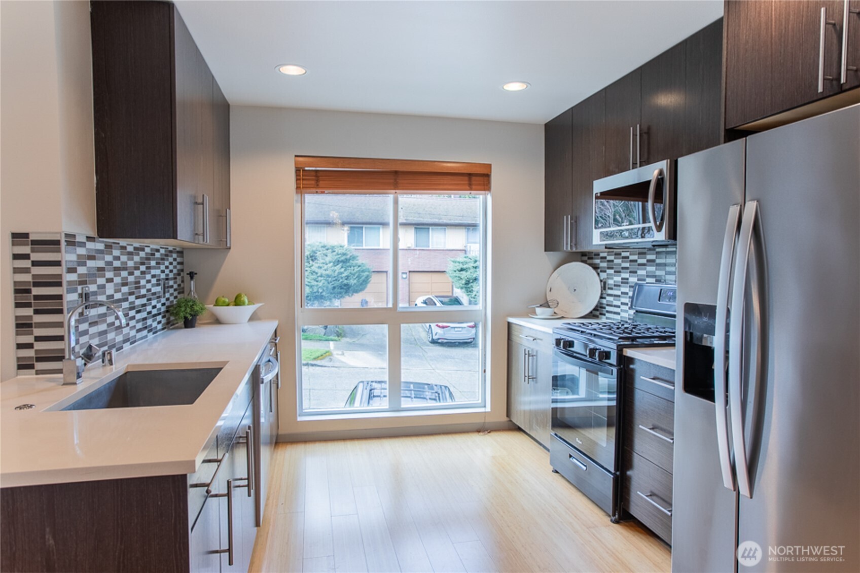 1465 South Columbian Way Seattle, WA 98144 - Photo 19 of 35 a kitchen with stainless steel appliances granite countertop a refrigerator a sink a stove and a refrigerator with wooden floor