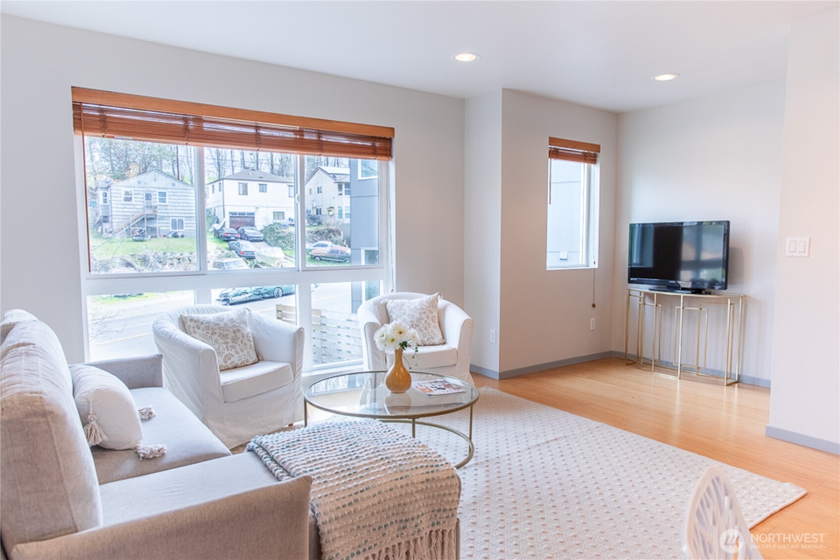 1465 South Columbian Way Seattle, WA 98144 - Photo 10 of 35 a living room with furniture a flat screen tv and a floor to ceiling window