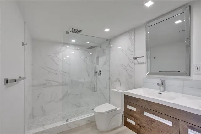 a bathroom with a sink toilet and shower