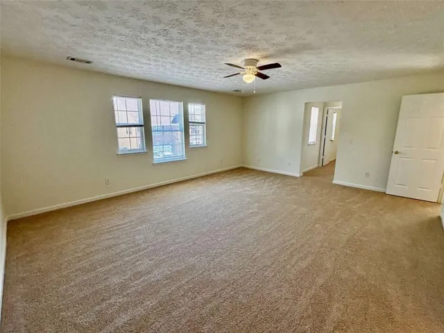 an empty room with a empty space and windows