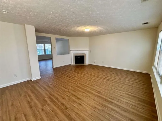 wooden floor in an empty room with a fireplace