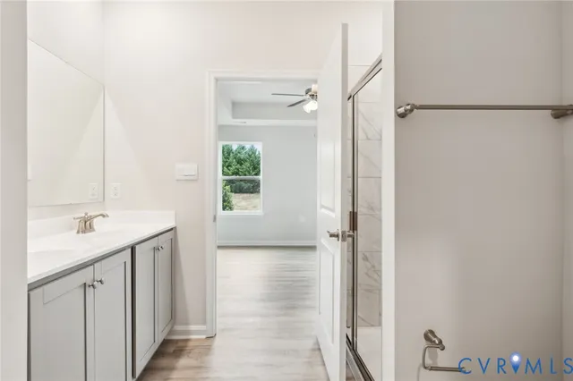 a bathroom with a granite countertop sink a mirror and a shower
