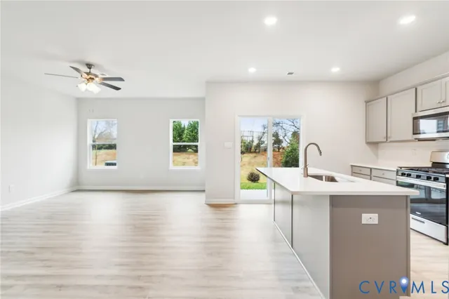 a view of a kitchen with a sink cabinets and wooden floor