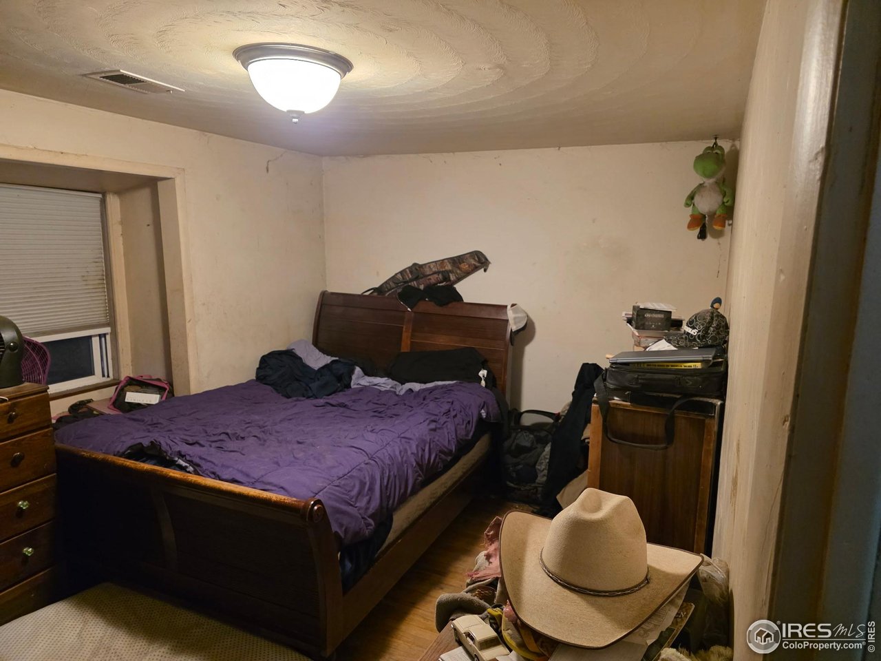 4355 Parfet Street Wheat Ridge, CO 80033 - Photo 34 of 40 a bedroom with a bed and cabinets