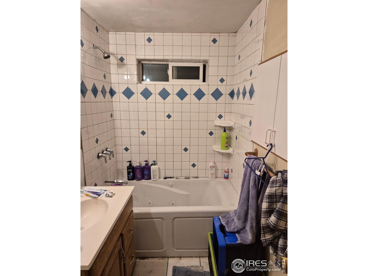 4355 Parfet Street Wheat Ridge, CO 80033 - Photo 40 of 40 a bathroom with a sink a mirror and a shower
