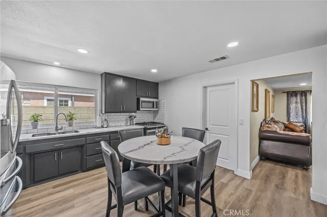 a kitchen with a table and chairs in it
