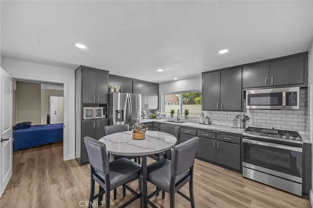 a kitchen with a dining table and chairs