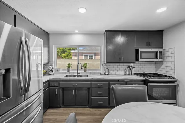 a kitchen with a sink stove and refrigerator