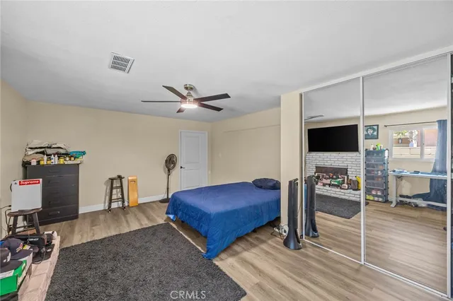a bedroom with furniture and a wooden floor