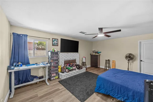 a bedroom with furniture and a flat screen tv