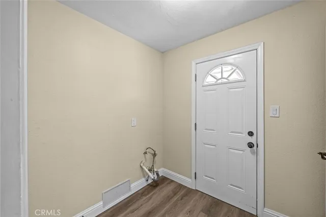 a view of a room with wooden floor