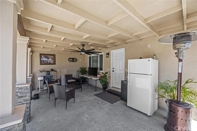 a room with furniture a refrigerator and a couch