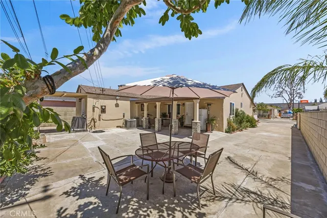 a view of a patio with table and chairs and potted plants