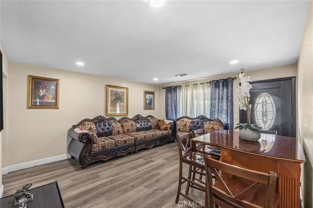 a living room with furniture a couch and a window