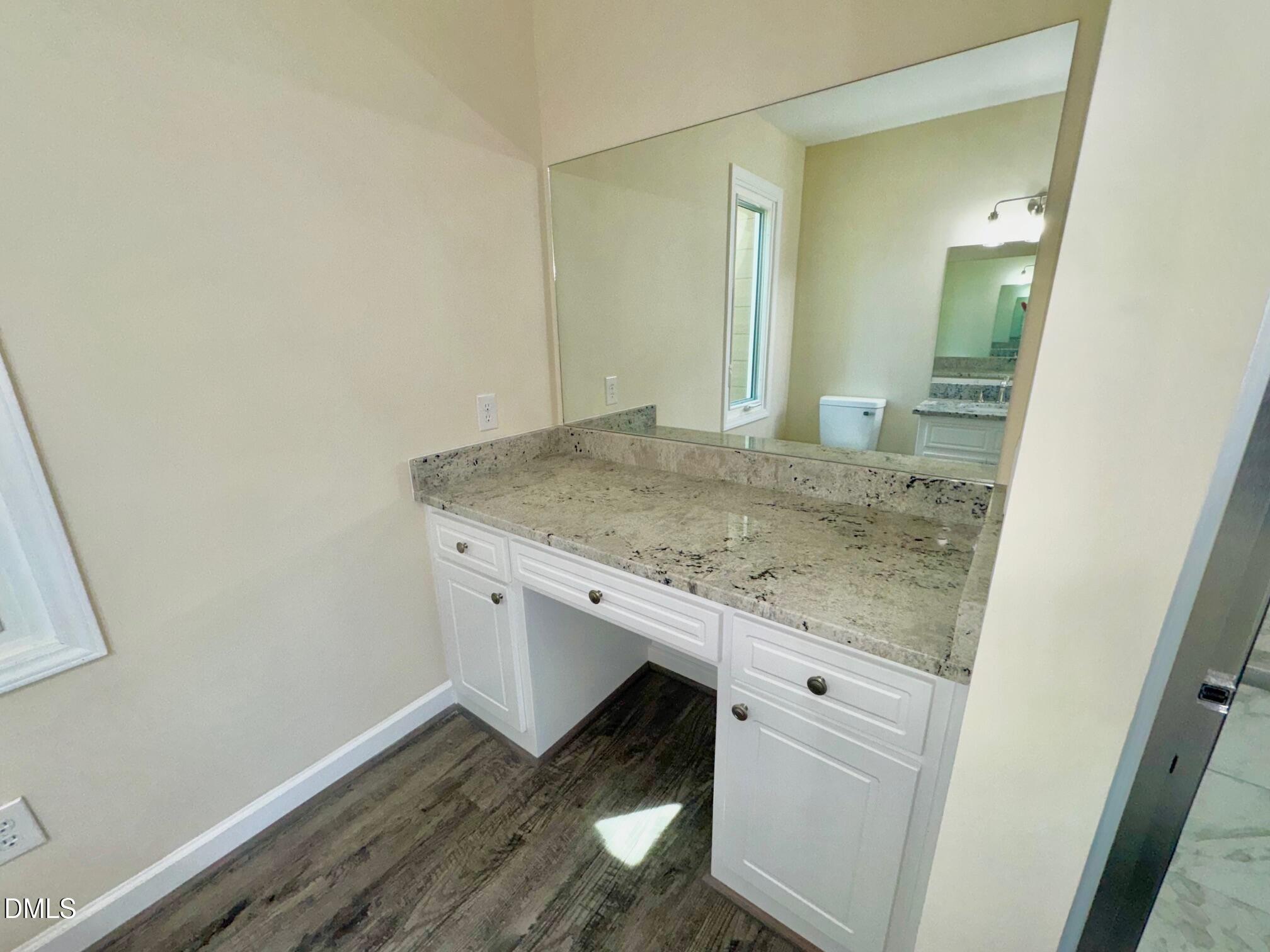 1720 Ross Mill Road Henderson, NC 27537 - Photo 25 of 42 a bathroom with a granite countertop sink and a mirror