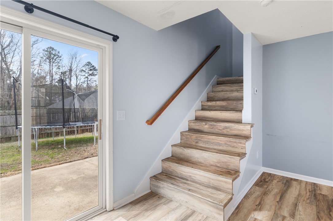 101 Buteos Way Anderson, SC 29621 - Photo 18 of 44 This interior features a wooden staircase, sliding glass doors, and durable flooring.
