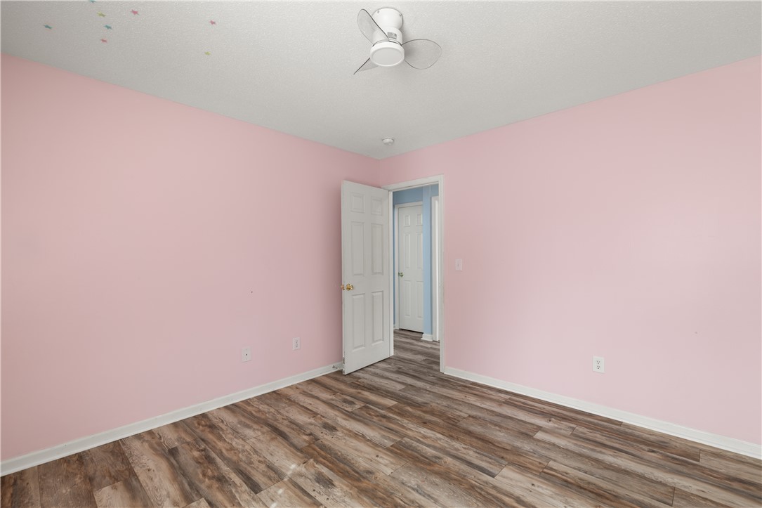 101 Buteos Way Anderson, SC 29621 - Photo 30 of 44 This spacious bedroom features warm wood flooring and a modern ceiling fan, creating a comfortable ambiance.