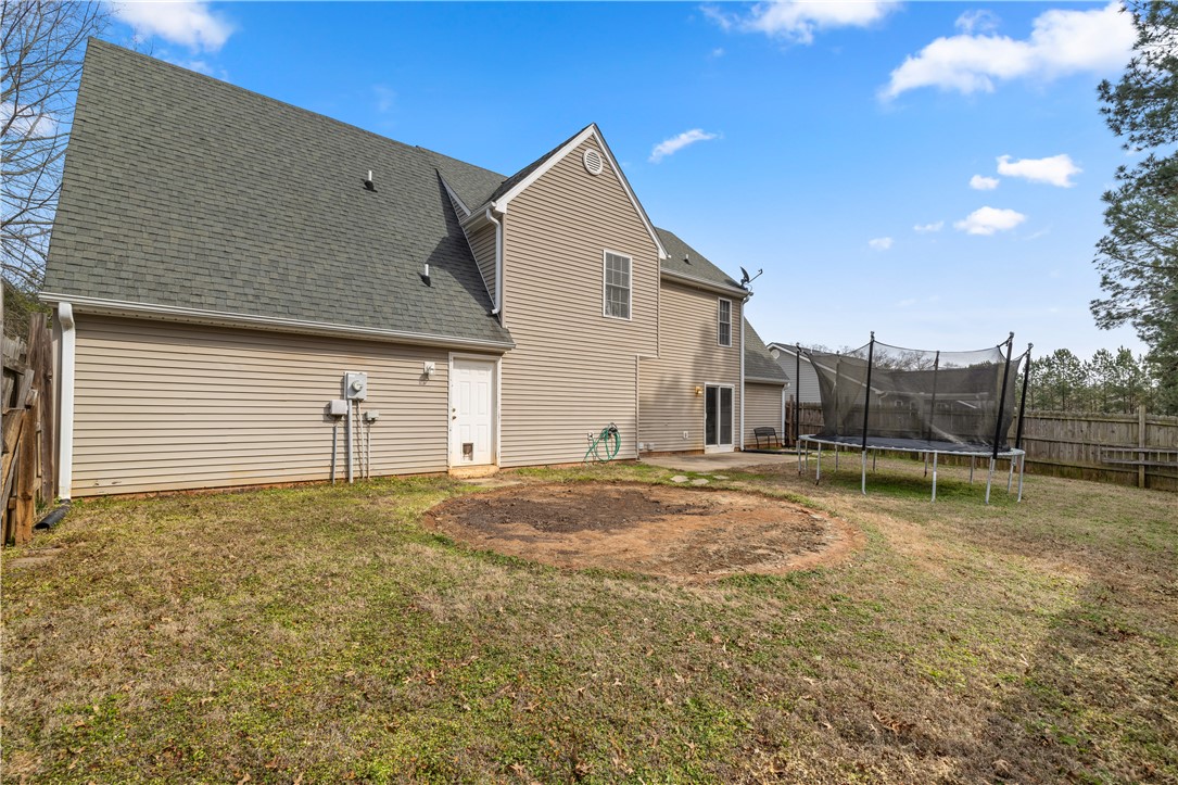 101 Buteos Way Anderson, SC 29621 - Photo 37 of 44 This spacious backyard offers a blend of natural charm and recreational opportunity, perfect for outdoor living.