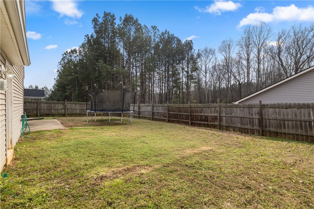 101 Buteos Way Anderson, SC 29621 - Photo 39 of 44 This spacious yard features a sturdy wood fence, offering privacy and a perfect backdrop for outdoor enjoyment.