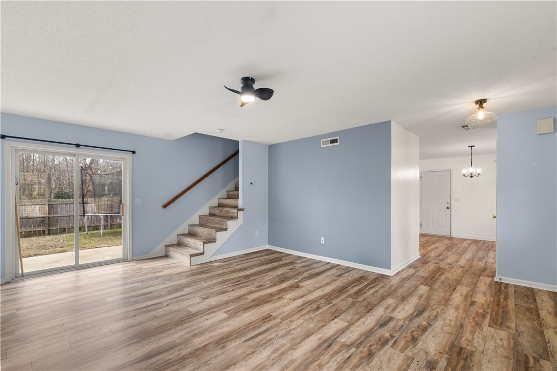101 Buteos Way Anderson, SC 29621 - Photo 6 of 44 Bright and airy living space featuring warm wood flooring and convenient patio access.