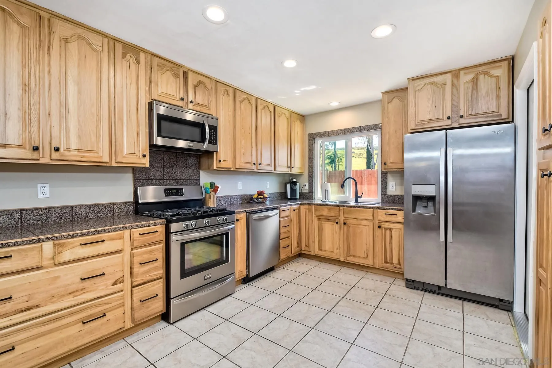 12861 Carriage Road Poway, CA 92064 - Photo 10 of 44 a kitchen with stainless steel appliances granite countertop a refrigerator sink and cabinets