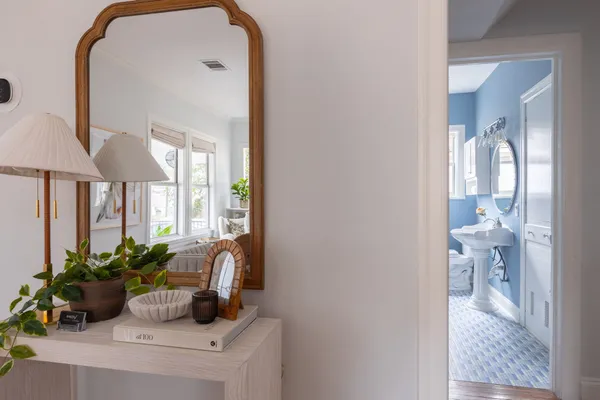 a dining room with furniture and a potted plant