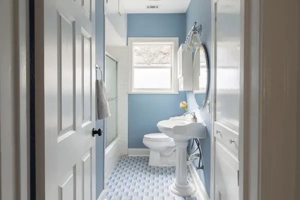 a bathroom with a sink toilet and shower