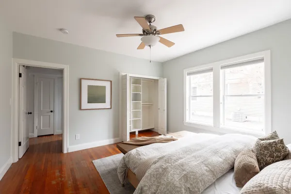 a bedroom with a bed and wooden floor
