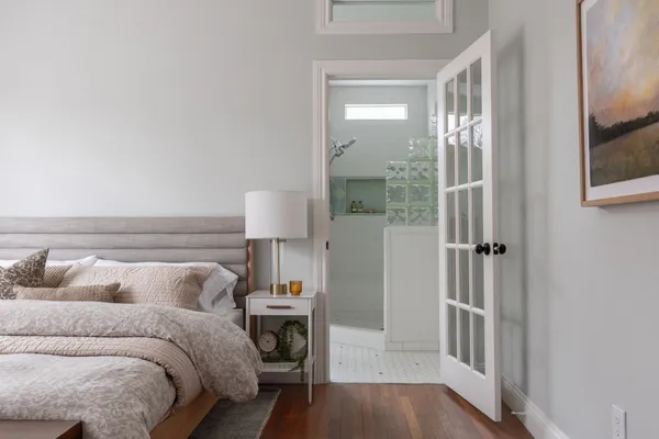 a bedroom with a bed and a mirror