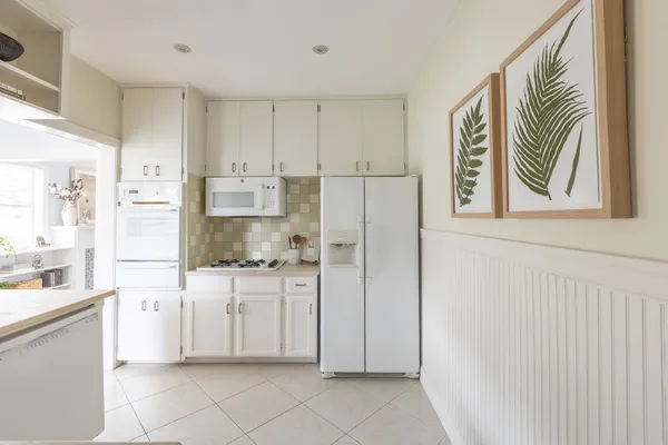a kitchen with stainless steel appliances a refrigerator and a stove top oven