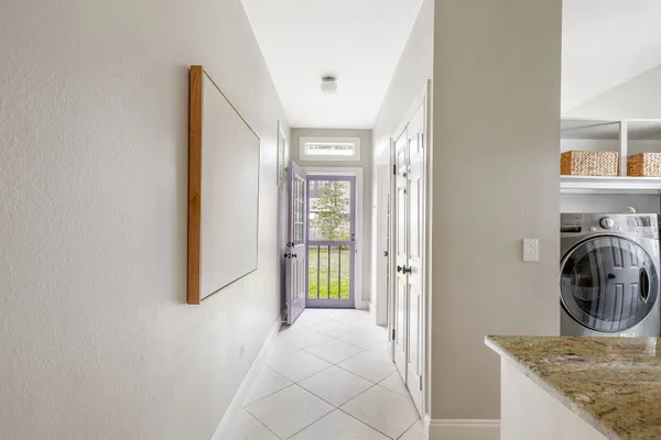 a view of a hallway with a washer and dryer