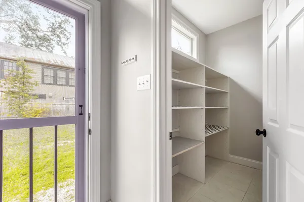 a view of a room with a large window and a hallway