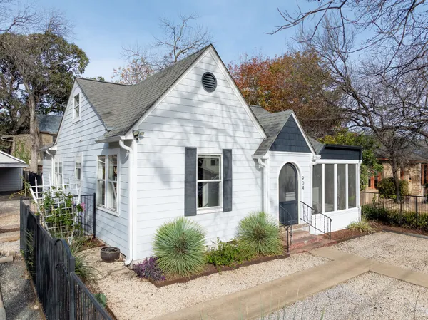 a front view of a house with garden