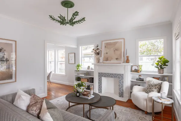 a living room with furniture a chandelier and a fireplace