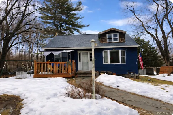 a front view of a house with a yard covered in snow