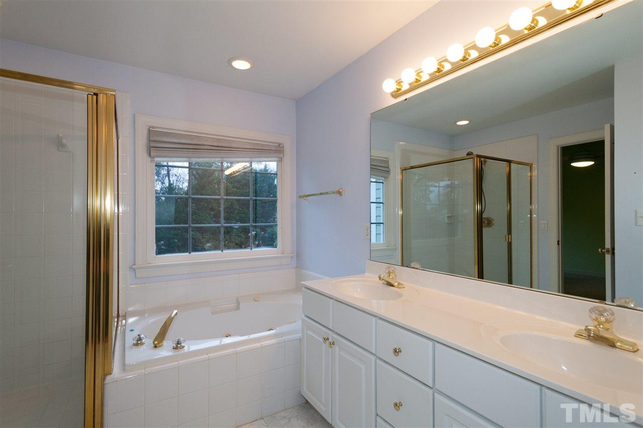 3536 La Costa Way Raleigh, NC 27610 - Photo 14 of 25 a bathroom with a tub a sink and a large mirror