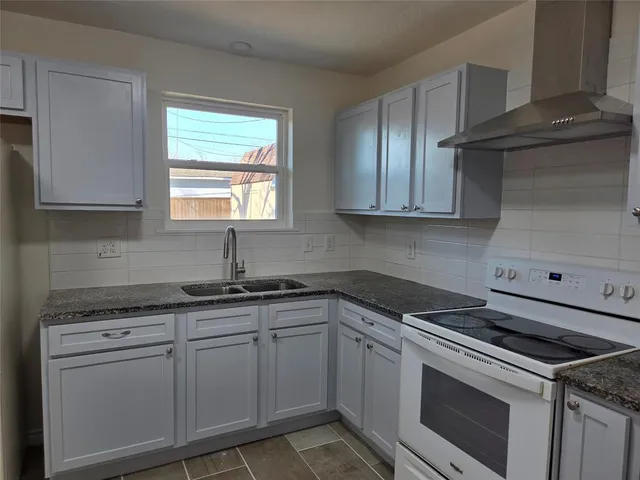 a kitchen with appliances cabinets and a window