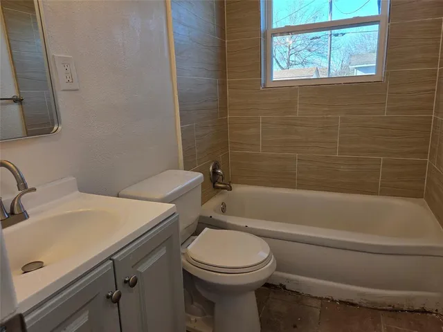 a bathroom with a sink a toilet and bathtub